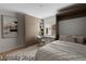 This bedroom includes built-in shelving, a desk, a neutral color palette, and a modern aesthetic at 11241 E Cimmarron Dr, Englewood, CO 80111