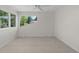 An empty room with carpet, a ceiling fan and two large windows offerring great natural light at 11241 E Cimmarron Dr, Englewood, CO 80111
