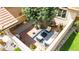 Aerial view of outdoor living space with seating area, mature trees, potted plants, and brick pavers at 11241 E Cimmarron Dr, Englewood, CO 80111