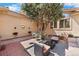 Outdoor living space featuring a seating area, mature tree and flower beds, perfect for enjoying the outdoors at 11241 E Cimmarron Dr, Englewood, CO 80111