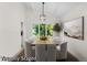 Dining room featuring an elegant light fixture, a wooden table and views to the landscaped backyard at 11241 E Cimmarron Dr, Englewood, CO 80111