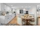 Spacious kitchen with white cabinetry, stainless steel appliances and a cozy breakfast nook at 11241 E Cimmarron Dr, Englewood, CO 80111