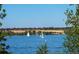Beautiful lake view featuring sailboats on the water and lush greenery along the shore at 11241 E Cimmarron Dr, Englewood, CO 80111