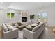 Cozy living room with a corner fireplace, neutral-toned furniture, and French doors leading to the outside at 11241 E Cimmarron Dr, Englewood, CO 80111