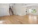 Open living room with hardwood floors, a staircase, and abundant natural light at 11241 E Cimmarron Dr, Englewood, CO 80111