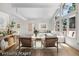 Bright, staged living room featuring large windows, vaulted ceilings and light hardwood floors at 11241 E Cimmarron Dr, Englewood, CO 80111
