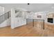 Modern living room with built-in shelving, fireplace, and railing at 11241 E Cimmarron Dr, Englewood, CO 80111