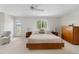 Spacious main bedroom with a king bed, lots of light, and a door to the outside at 11241 E Cimmarron Dr, Englewood, CO 80111