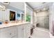 Bright bathroom featuring a marble countertop, walk-in shower, and tile flooring at 562 N Gilpin St, Denver, CO 80218