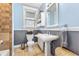 Charming bathroom with gray wainscoting, pedestal sink, and built-in storage at 562 N Gilpin St, Denver, CO 80218