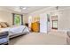 Cozy bedroom with a ceiling fan, dresser, and view into the hallway at 562 N Gilpin St, Denver, CO 80218