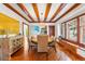 Elegant dining room with hardwood floors, wood ceiling beams, and built-in window seat at 562 N Gilpin St, Denver, CO 80218