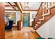 Elegant foyer with hardwood floors, a staircase, stained glass door and wood trim at 562 N Gilpin St, Denver, CO 80218