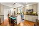Bright kitchen features an island with granite counters, stainless appliances, and hardwood floors at 562 N Gilpin St, Denver, CO 80218