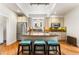Bright kitchen features an island with granite counters, stainless appliances, and hardwood floors at 562 N Gilpin St, Denver, CO 80218