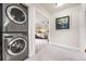 Hallway laundry area with a stacked washer and dryer with view into another room at 562 N Gilpin St, Denver, CO 80218