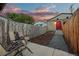 Serene backyard with lounge chairs, gravel path, and well-maintained fence at 3321 Navajo St, Denver, CO 80211
