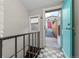 Charming entryway featuring a turquoise door, black and white tile, and staircase at 3321 Navajo St, Denver, CO 80211