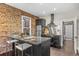 Modern kitchen with exposed brick, stainless steel appliances, and counter seating at 3321 Navajo St, Denver, CO 80211