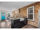 Bright kitchen and living room with an exposed brick wall at 3321 Navajo St, Denver, CO 80211