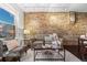 Charming living area featuring exposed brick, contemporary furniture, and lots of natural light at 3321 Navajo St, Denver, CO 80211
