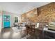 Living room featuring exposed brick wall, dark hardwood floors, and stylish modern furniture at 3321 Navajo St, Denver, CO 80211