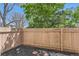 Cozy backyard with mulch bed and tall wood fence at 3550 S Harlan St # 177, Denver, CO 80235