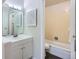Bright bathroom with a shower and tub combo and white vanity and sink with medicine cabinet and mirror, at 3550 S Harlan St # 177, Denver, CO 80235