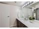 Bright bathroom with marble countertop, vanity, and neutral paint at 3550 S Harlan St # 177, Denver, CO 80235