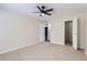 Neutral bedroom with walk in closet and view to living space with carpet and great natural light at 3550 S Harlan St # 177, Denver, CO 80235