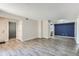 Open-concept living room with view to kitchen, modern flooring, neutral walls, perfect for entertaining and relaxation at 3550 S Harlan St # 177, Denver, CO 80235