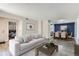 Bright living room showcasing modern decor, gray walls and flooring, adjacent to dining area and bedroom for seamless living at 3550 S Harlan St # 177, Denver, CO 80235