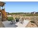 Outdoor patio area with seating around a fire pit, a fenced yard, and views of the surrounding neighborhood at 4536 Shady Path Ln, Castle Rock, CO 80104