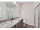 This bathroom boasts a granite countertop, stylish gray cabinets, modern fixtures, and a glass-enclosed shower at 4536 Shady Path Ln, Castle Rock, CO 80104