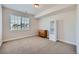 This bedroom has neutral carpet and walls with a window providing lots of natural light at 4536 Shady Path Ln, Castle Rock, CO 80104
