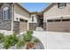 Charming front exterior with two-car garage, stone accents, well-maintained landscaping, and inviting curb appeal at 4536 Shady Path Ln, Castle Rock, CO 80104