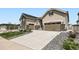 Exterior of home boasting stone accents, a well-kept lawn, a wide driveway, and a two-car garage at 4536 Shady Path Ln, Castle Rock, CO 80104