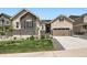 Charming home featuring stone accents, a well-manicured lawn, and a two-car garage with a warm and inviting facade at 4536 Shady Path Ln, Castle Rock, CO 80104