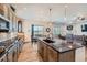 Bright kitchen features an island with sink, granite countertops, and seamless access to the living and dining areas at 4536 Shady Path Ln, Castle Rock, CO 80104