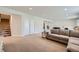 Spacious living room with neutral walls, carpet, and decor with a staircase and sliding closet door at 4536 Shady Path Ln, Castle Rock, CO 80104