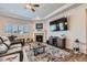 Cozy living room with fireplace, large TV, tray ceiling, and plush seating, creating a relaxing atmosphere at 4536 Shady Path Ln, Castle Rock, CO 80104