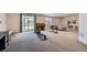 Spacious living area features large sliding glass doors, neutral carpet and decor, and ample room for activities at 4536 Shady Path Ln, Castle Rock, CO 80104