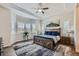 Spacious bedroom with tray ceilings, natural light from large windows, and a comfortable, stylish bed with decorative pillows at 4536 Shady Path Ln, Castle Rock, CO 80104