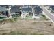 A view of suburban homes showcasing backyard patios, vibrant green lawns, and tidy white fences at 4536 Shady Path Ln, Castle Rock, CO 80104