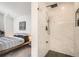 Modern bathroom with a glass enclosed shower, sleek black hardware, and ensuite access to bedroom at 6550 S Oak Ct, Littleton, CO 80127