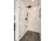 Spa-like bathroom featuring a glass shower with a rainfall showerhead, and luxurious marble tiling at 6550 S Oak Ct, Littleton, CO 80127