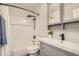Modern bathroom featuring subway tile shower, black fixtures, and a vanity with storage at 6550 S Oak Ct, Littleton, CO 80127
