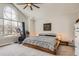 Bright bedroom with a modern platform bed, statement window, ceiling fan, and workout bike at 6550 S Oak Ct, Littleton, CO 80127
