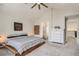 Bedroom with a unique window design, a modern bed frame, and an ensuite bathroom at 6550 S Oak Ct, Littleton, CO 80127