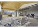Spacious covered deck featuring seamless indoor/outdoor living with modern furniture and mountain views at 6550 S Oak Ct, Littleton, CO 80127